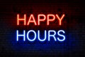Happy hours. Neon sign with luminous letters of red and blue on black brick wall.