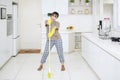 Happy housekeeper dancing with a broom Royalty Free Stock Photo