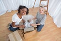 Happy housemates unpacking boxes in new home Royalty Free Stock Photo