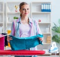 Happy housewife doing ironing at home Royalty Free Stock Photo