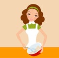 Happy housewife holding a bowl and whisk