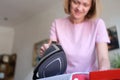 Happy housewife ironing clothes at home close-up. Royalty Free Stock Photo