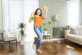 Happy housewife makes house cleaning holding rag spray bottle detergent Royalty Free Stock Photo
