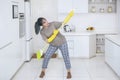 Happy housewife playing guitar with a broom Royalty Free Stock Photo