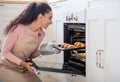 Happy Housewife. Portrait Of Smiling Millennial Woman Baking In Kitchen Royalty Free Stock Photo