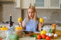 happy housewife reading cooking book in her kitchen