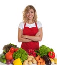 Happy housewife with red apron and fresh vegetables Royalty Free Stock Photo