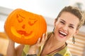 Happy housewife showing a big orange pumpkin Jack-O-Lantern Royalty Free Stock Photo