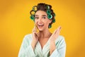 Happy Housewife Talking On Phone Standing On Yellow Studio Background