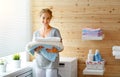 Happy housewife woman in laundry room with washing machine Royalty Free Stock Photo