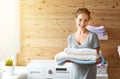 Happy housewife woman in laundry room with washing machine