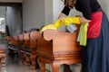 The happy housewives in rubber gloves wipe the dust with a spray while cleaning the tables and chairs cleaning concept