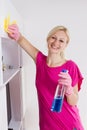 Happy houswife cleaning furniture at home Royalty Free Stock Photo