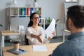 Happy HR manager holding CV, offering handshake to job applicant during employment interview at modern office Royalty Free Stock Photo