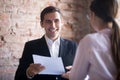 Happy hr manager with resume looking at female job seeker.