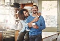 Happy, hugging and smiling young in love couple bonding in a kitchen at home. Romantic life partners enjoying the Royalty Free Stock Photo