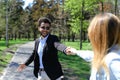 Happy husband leads wife and smiles with simples on cheeks in slow motion Royalty Free Stock Photo