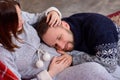 Happy husband listens to baby heartbeat lying on belly of his pregnant wife