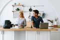 Happy husband remote working or distance learning online from home office while his wife cooking toast bread by Air Fryer machine