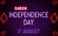 Happy Independence Day of Gabon, 17 August. World National Days Neon Text Effect on bricks background