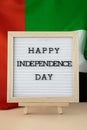 HAPPY INDEPENDENCE DAY text frame on United Arab Emirates waving flag made from silk material. Commemoration Day Muslim Royalty Free Stock Photo