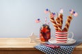 Happy Independence Day, 4th of July celebration concept with summer fresh fruit drink, twisted hot dog sausages and USA flag on Royalty Free Stock Photo