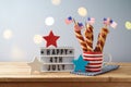 Happy Independence Day, 4th of July celebration concept with twisted hot dog sausages and USA flag on wooden table Royalty Free Stock Photo