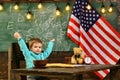 Happy independence day of the usa. School kid at lesson in 4th of july. Little boy eat bread at American flag at Royalty Free Stock Photo