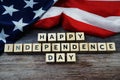 Happy Independence Day Word alphabet letters with USA flag on wooden background Royalty Free Stock Photo