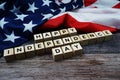 Happy Independence Day Word alphabet letters with USA flag on wooden background Royalty Free Stock Photo