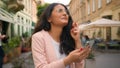 Happy Indian Arabian woman girl businesswoman crossed fingers praying wishing gesture looking mobile phone business Royalty Free Stock Photo