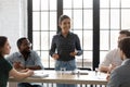 Happy Indian business leader holding corporate meeting with diverse team Royalty Free Stock Photo