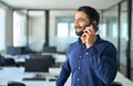 Happy Indian business man talking on mobile cell phone making call in office. Royalty Free Stock Photo