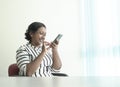 Happy Indian businesswoman leave a voice message on her cellphone Royalty Free Stock Photo