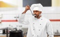 Happy indian chef tasting food by ladle at kitchen Royalty Free Stock Photo