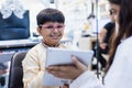 Happy Indian child boy wearing spectacles in glasses shop. Patient kid male checkup iris examines ophthalmological clinic of