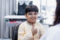 Happy Indian child boy wearing spectacles in glasses shop. Patient kid male checkup iris examines ophthalmological clinic of