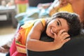 Happy indian child having fun sitting on sofa with parents at home - Focus on girl