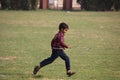 Happy Indian child running in the grass