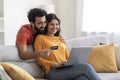 Happy Indian Couple Shopping Online Via Laptop And Credit Card At Home Royalty Free Stock Photo