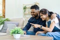 Happy indian Couple Using Laptop Browsing Internet Together on sofa at home Royalty Free Stock Photo