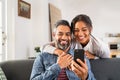 Happy indian couple using smartphone at home Royalty Free Stock Photo