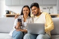 Happy Indian Couple Using Smartphone And Laptop Computer At Home Royalty Free Stock Photo