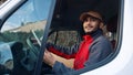 Happy indian courier using tablet in the van