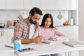 Happy indian dad helping school child teen daughter learning at home. Royalty Free Stock Photo