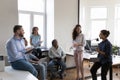 Happy Indian employee sharing ideas with coworkers on briefing Royalty Free Stock Photo