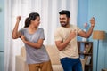 Happy Indian Excited young couples dancing at there new home after purchasing - concept of New Beginnings, Exciting Royalty Free Stock Photo