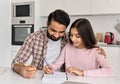 Happy indian father helping school child teen daughter studying at home. Royalty Free Stock Photo