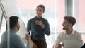 Smiling woman speaker laugh talking with colleagues at briefing Royalty Free Stock Photo