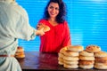 Happy indian female salling fresh traditional buns in bazar